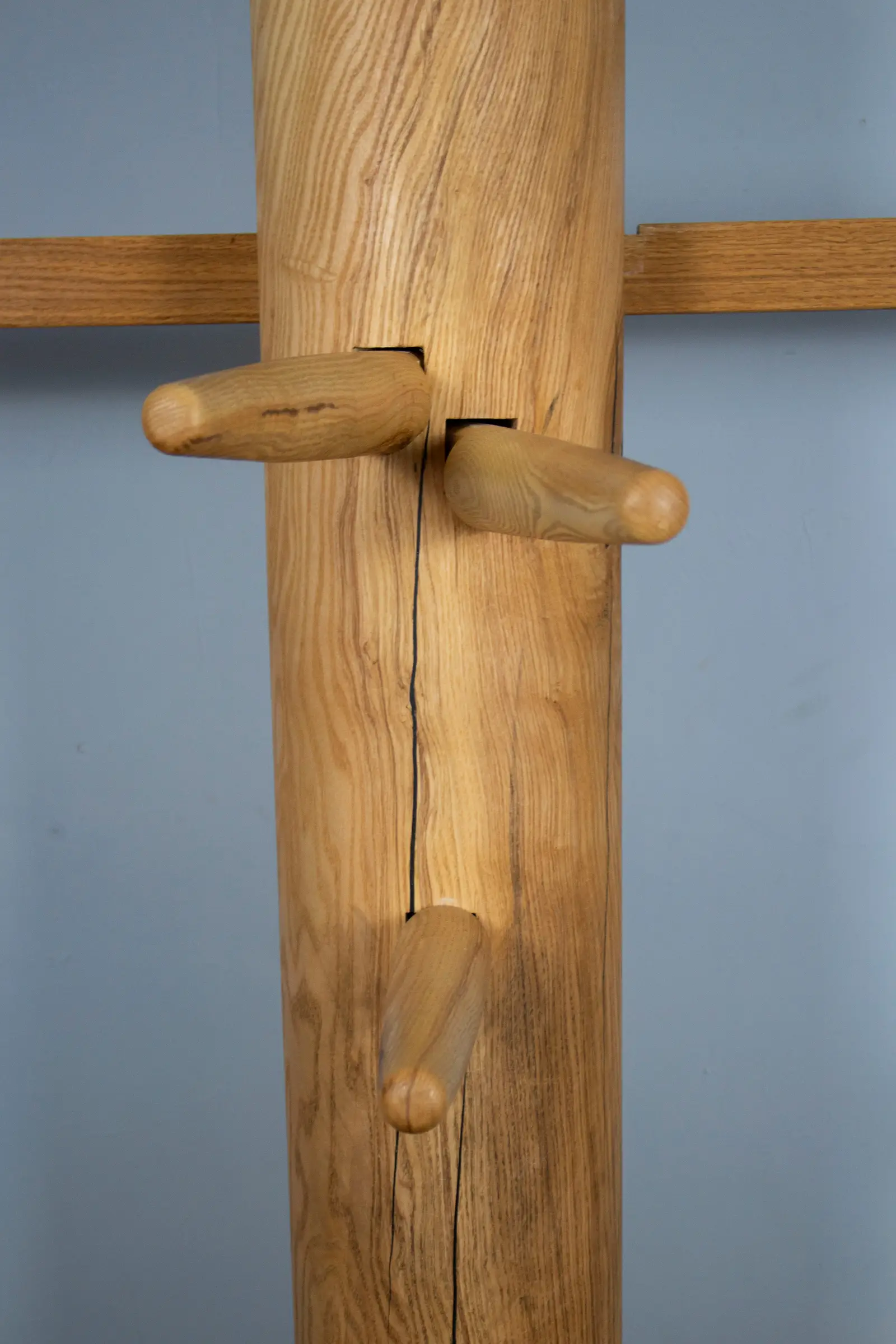 Close-up of the Wing Chun wooden dummy's arms and ash trunk detail